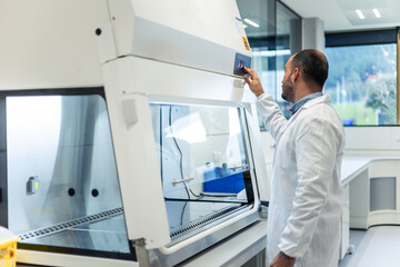 Scientist working with a fume hood in a scientific laboratory
