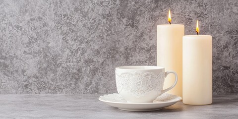 Custom Tea Cup and Saucer giftset for Valentine's Day concept. A cozy scene with a cup and two lit candles on a gray background
