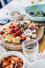 Rustic farm-to-table dining table with fresh charcuterie, floral centerpiece, and artisanal dishes, showcasing natural living and gourmet simplicity