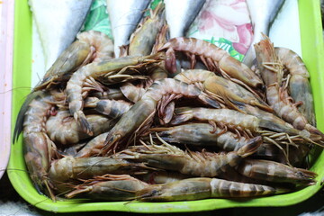 Fresh raw shrimps at the market for sell. Heap of prawns with top view. Shrimp pattern, prawn texture. fresh shrimp prawns for cooking seafood food in the kitchen or buy shrimps on shop at the seafood