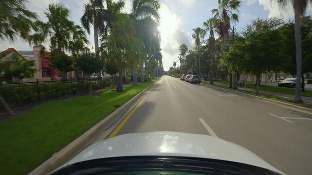 POV car driving on Venice streets. Town American avenue between southern architecture in Florida touristic area.