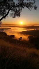 Obraz premium Breathtaking sunrise over misty hills with golden light