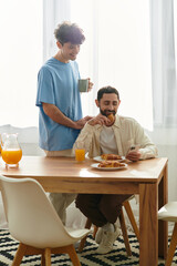 Joyful morning breakfast for a loving gay couple in a modern apartment