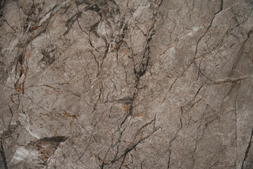 Close-up of a stone texture featuring layered patterns and cracks