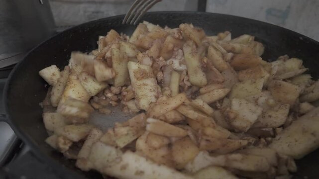 pan with apples cooking for German cake