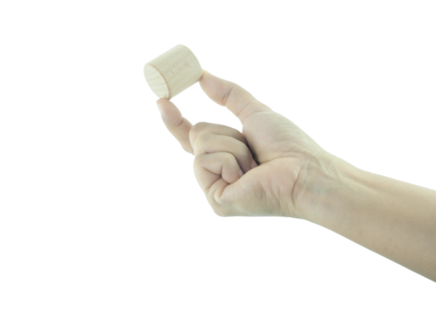 Female hand holding Wood block isolated on white background.