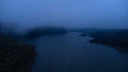 Aerial view of beautiful fog on the lake in the morning. Fresh early morning in the forest near the river. Beautiful sunrise in the forest with fog.