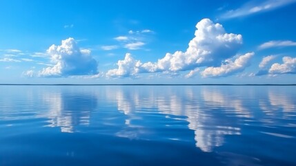 Fototapeta premium Serene blue sky with fluffy clouds reflected.