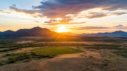 Obraz premium Majestic Sunset Over Breathtaking Mountain Range Landscape with Dramatic Sky and Serene Atmosphere