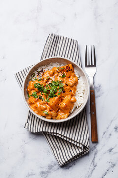 Vegan curry chickpea stew with vegetables in white bowl.