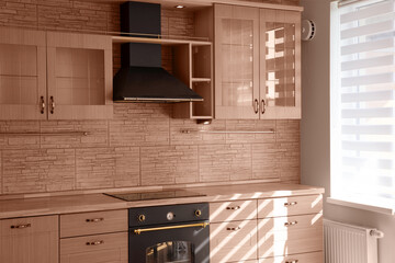 Fototapeta premium Modern interior of a combined kitchen and living room with colors of the year 2025 Mocha Mousse in classic style