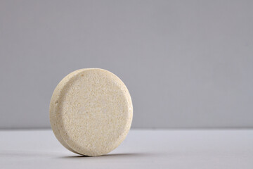 Extreme macro photography of effervescent tablet isolated on white background