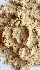 Close up of powder of Fuller's earth used a in as a ingredient in face pack,spa,beauty products,and in facials, papercraft, with white tones