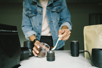 Preparing coffee by scooping the coffee powder into a manual coffee maker to make coffee at home. Concept.