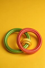 Fototapeta premium Studio shot of three interlocking rings in red, green, and yellow. Symbolic unity rings representing Black History Month colors on a clean background. 