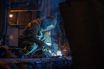 Fix Service of industry mining factory. Welder repairs excavator truck bucket in repair garage
