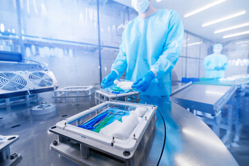 Medicine industry, production of medical instruments. Worker working on factory line for surgical...