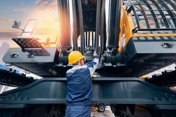 Machinery tractor mechanic checks hydraulic hose system equipment on excavator. Concept industry...