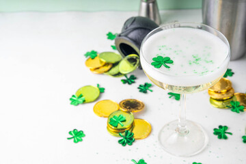 Patrick day alcohol bar drinks menu, party invitation, gold green cocktail garnished with shamrock, green sugar sprinkles, for St. Patrick's Day celebrations, with festive decor and bar utensils