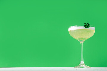 Patrick day alcohol bar drinks menu, party invitation, gold green cocktail garnished with shamrock, green sugar sprinkles, for St. Patrick's Day celebrations, with festive decor and bar utensils