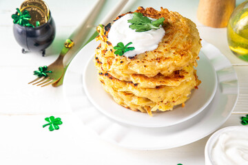 Vegetarian comfort food, potato pancakes. Traditional european vegetable dish, potato fritters, cutlets, latkes (flapjacks, hash brown or potato vada) with sour cream