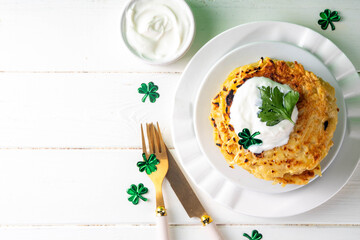 Vegetarian comfort food, potato pancakes. Traditional european vegetable dish, potato fritters, cutlets, latkes (flapjacks, hash brown or potato vada) with sour cream