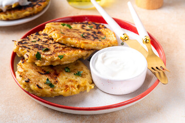 Vegetarian comfort food, potato pancakes. Traditional european vegetable dish, potato fritters, cutlets, latkes (flapjacks, hash brown or potato vada) with sour cream