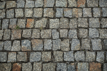 Old paving stones in the historical European city center, pavement texture, background, pavement in the old town of Warsaw