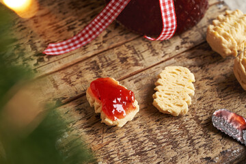 Homemade Christmas cookies in the process of filling with strawberry marmalade