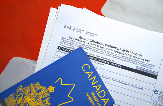 Applying for new passport in Canada with application form and flag in the backdrop.