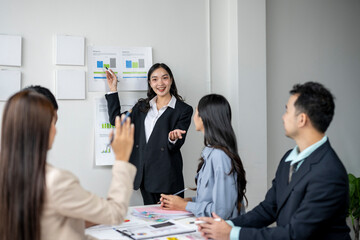 A woman is giving a presentation to a group of people in a conference room
