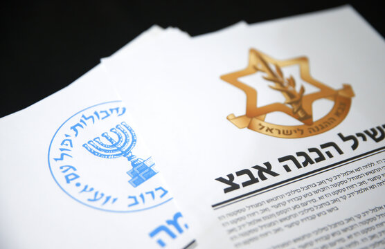 1.7.2025, United States. Mossad and Israel Defense Forces reports concept close up shot design on black surface in paper form, illustrative editorial. Secret intelligence of Israel with reports