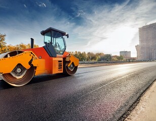 construction zone with roller compacting hot asphalt road
