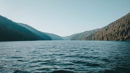 Calm lake nestled between mountains at dawn. Possible stock photo use.