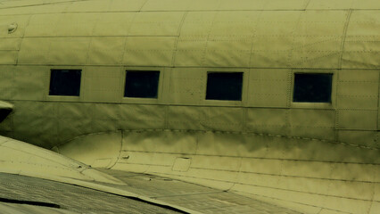 Part of the body of an old airplane, a window.