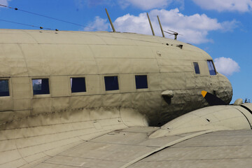 An old military transport plane against the sky.