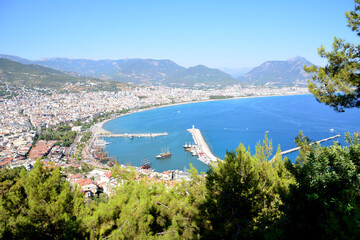 Alanya town with a lighthouse and mountains in the background  