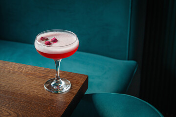 Clover Club cocktail on a wooden table in the restaurant