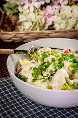 Healthy broccoli salad with feta cheese,  tomatoes, eggs.