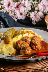 Meatballs pork and mashed potatoes topped with paprika gravy.