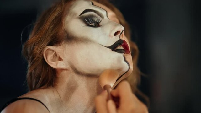Beautiful actress doing makeup before theatrical performance, side portrait. Internal struggle and psychological disorders, woman want to be another person, playing role for society, dual personality
