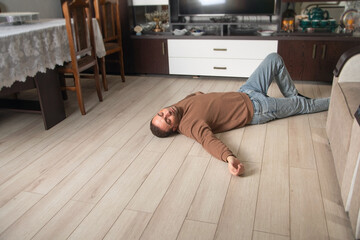 Caucasian unconscious man at home.