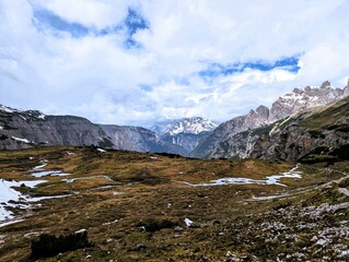 Partly snow-covered mountain landscape in the European Alps and the Italian Dolomites. Mountain...