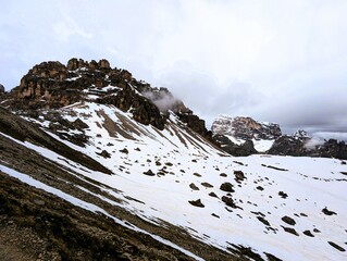 Partly snow-covered mountain landscape in the European Alps and the Italian Dolomites. Mountain...