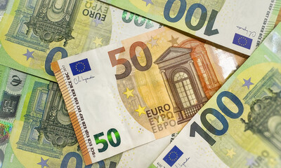 Banknotes of 100 dollar Banknotes of 20, 50, 100 euros Background of cash dollar and euro bills. American currency European currency United States Cash banknotes Financial Money background concept.