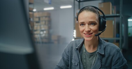 Warehouse of postal service or E-commerce store: Female logistics manager in headset talks on call...