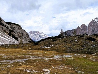 Partly snow-covered mountain landscape in the European Alps and the Italian Dolomites. Mountain...