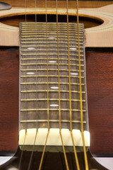 Obraz premium Modern style wooden acoustic guitar isolated, showing some specific parts, with metal strings, ideal for Rock music