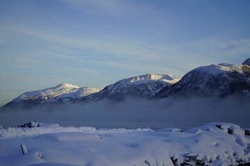 Serene winter mountain landscape with mist.