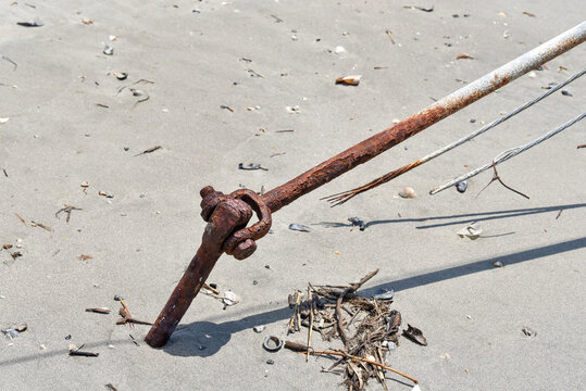 Rusty Utility Anchor on Beach